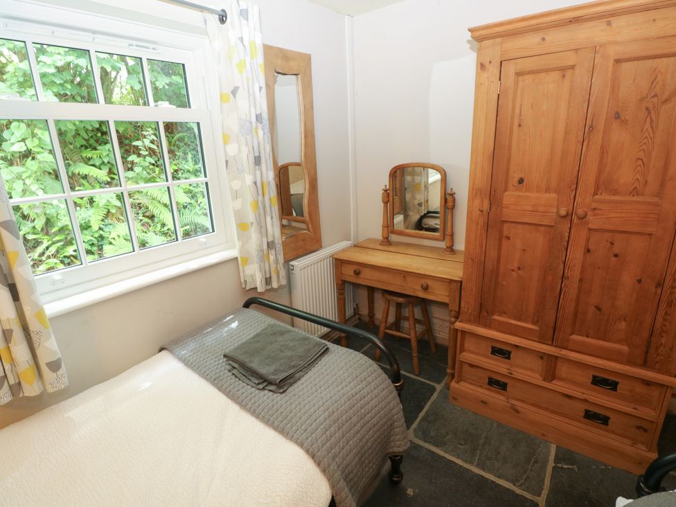A bedroom with a bed and a wardrobe at Glas y Dorlan Nevern near Newport, Pembrokeshire