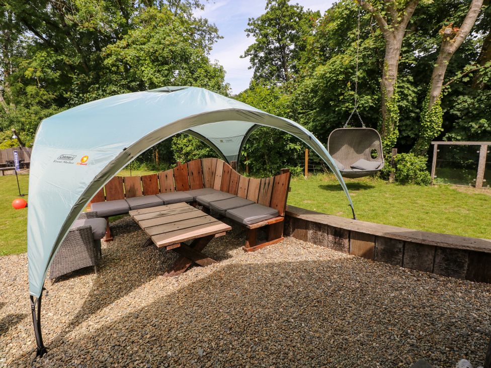 An outdoor seating area with a canopy and swing at Glas y Dorlan, Nevern near Newport, Pembrokeshire