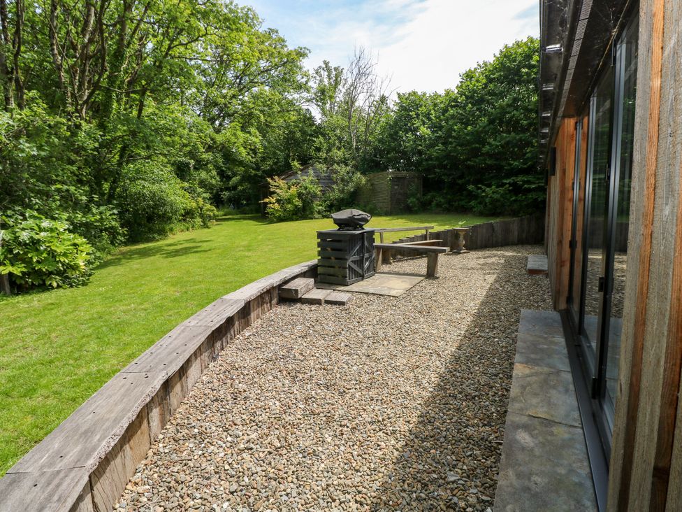 A garden with gravel, grass, a table and a barbecue at Glas y Dorlan Nevern near Newport, Pembrokeshire