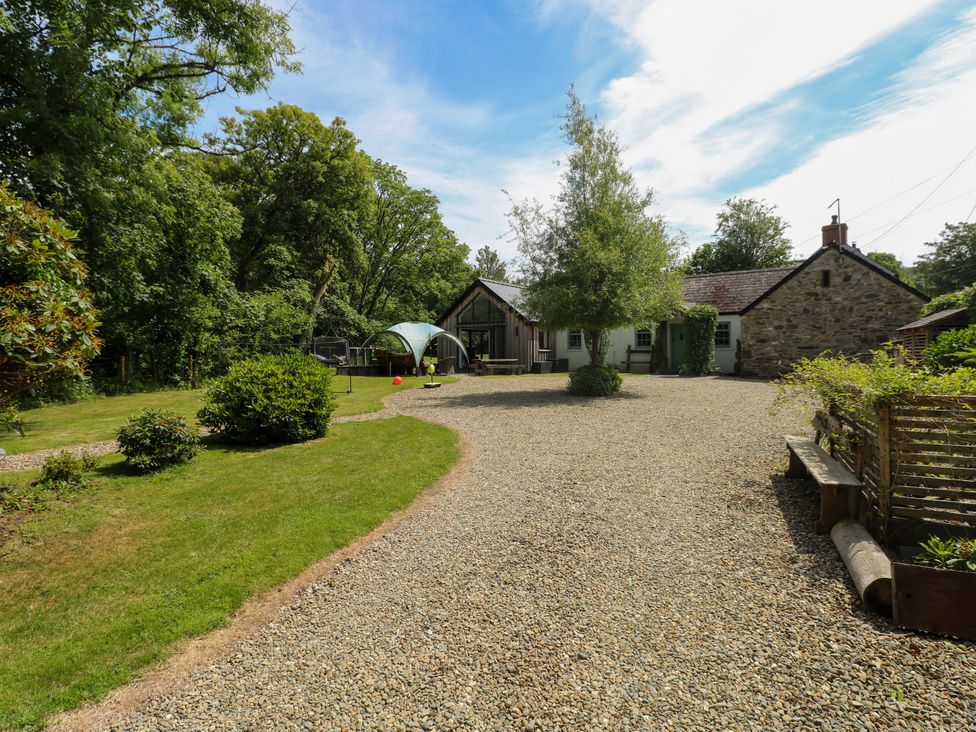 A garden with a house and gravel driveway at Glas y Dorlan Nevern near Newport, Pembrokeshire
