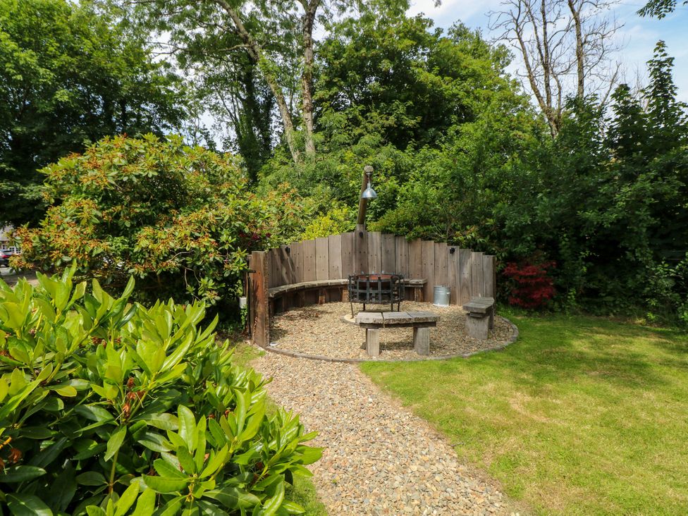 A garden with a fire pit surrounded by benches at Glas y Dorlan in Nevern near Newport, Pembrokeshire