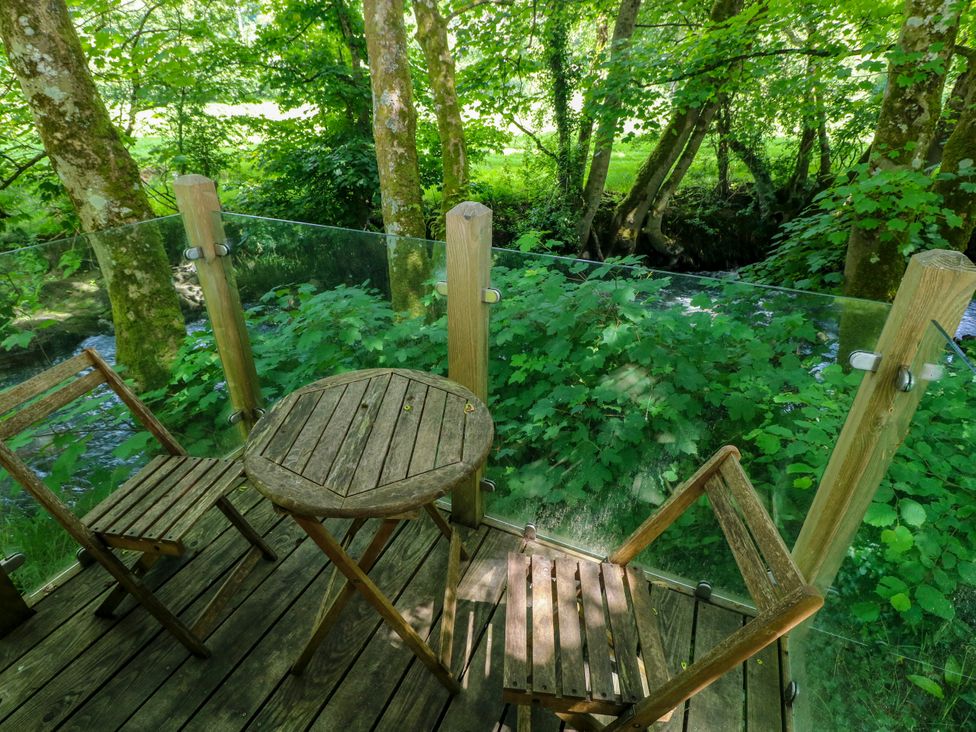 A wooden table and chairs in an outdoor seating area at Glas y Dorlan, Nevern near Newport, Pembrokeshire