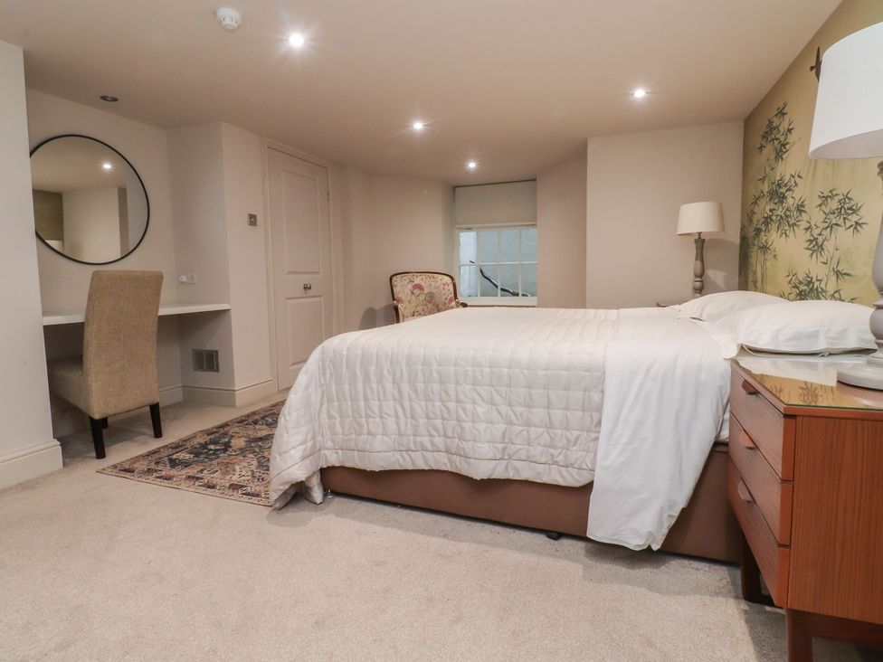 A bedroom with a bed and a desk at Paramount Apartments in Lytham St. Annes