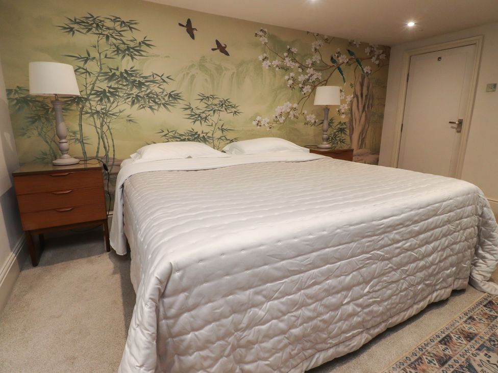 A bedroom with a bed and nightstands at Paramount Apartments in Lytham St. Annes