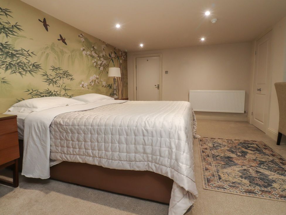 A bedroom with a bed and rug at Paramount Apartments Lytham St. Annes