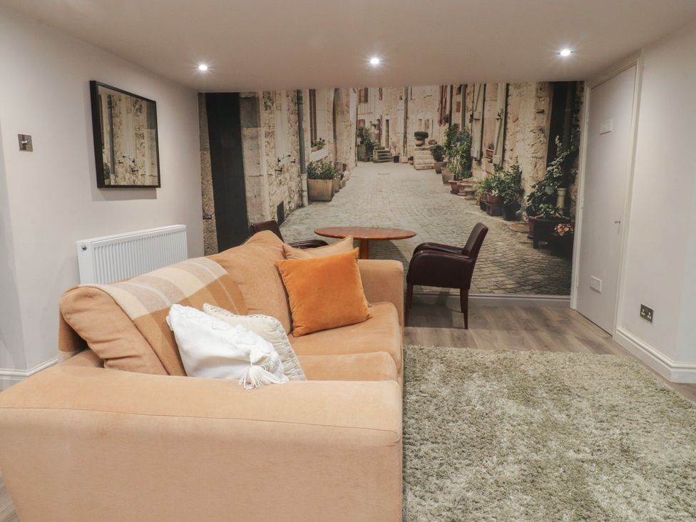 A living room with a sofa and table at Paramount Apartments in Lytham St. Annes