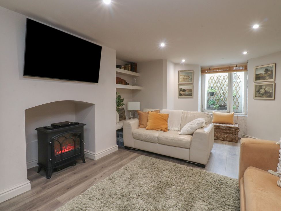 A living room with a sofa and television at Paramount Apartments in Lytham St. Annes