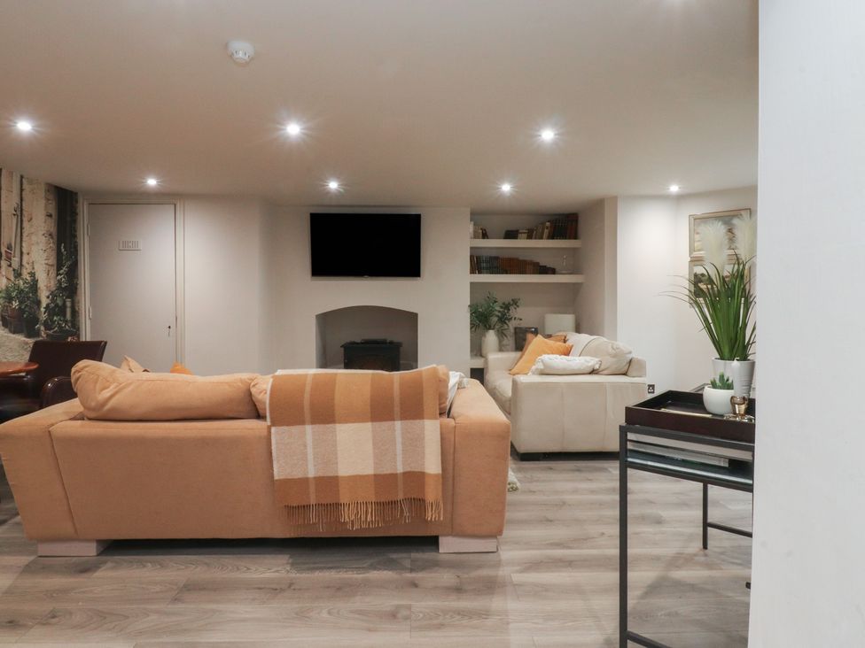 A living room with a sofa and a television at Paramount Apartments Lytham St. Annes