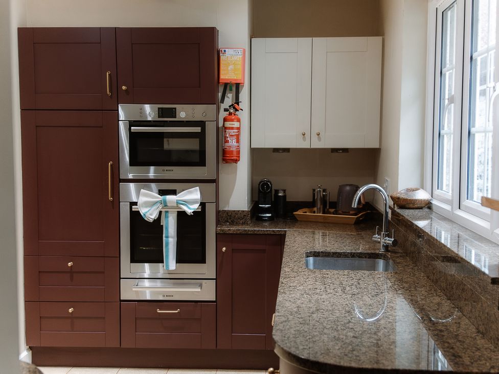 A kitchen with appliances and cabinets at Grey Walls in Glenridding