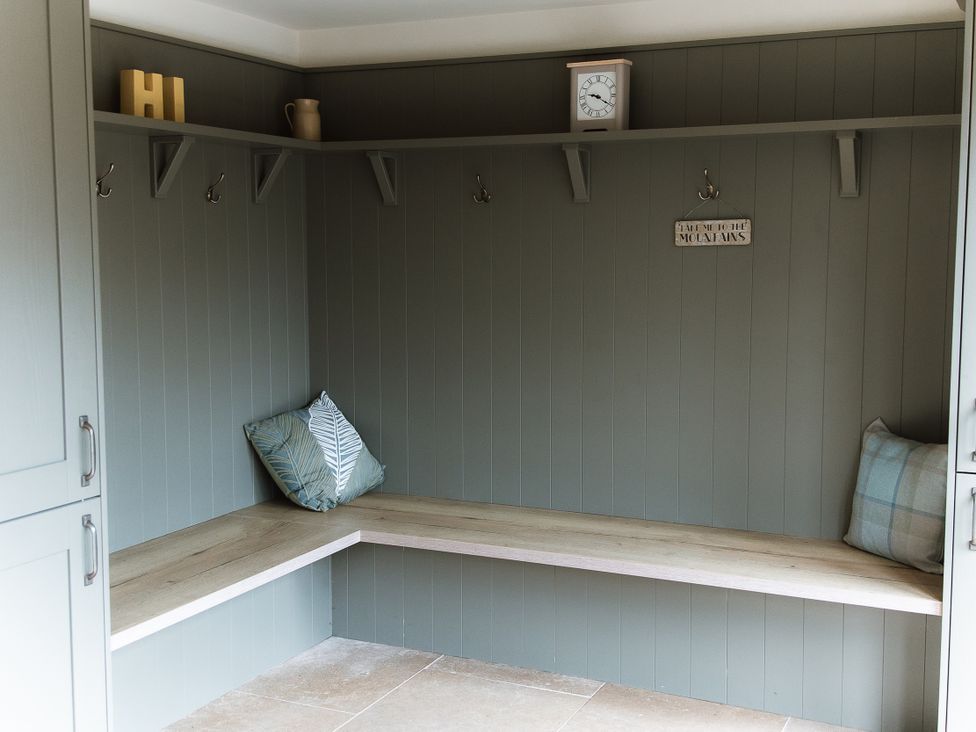 A mudroom with hooks and a bench at Grey Walls in Glenridding