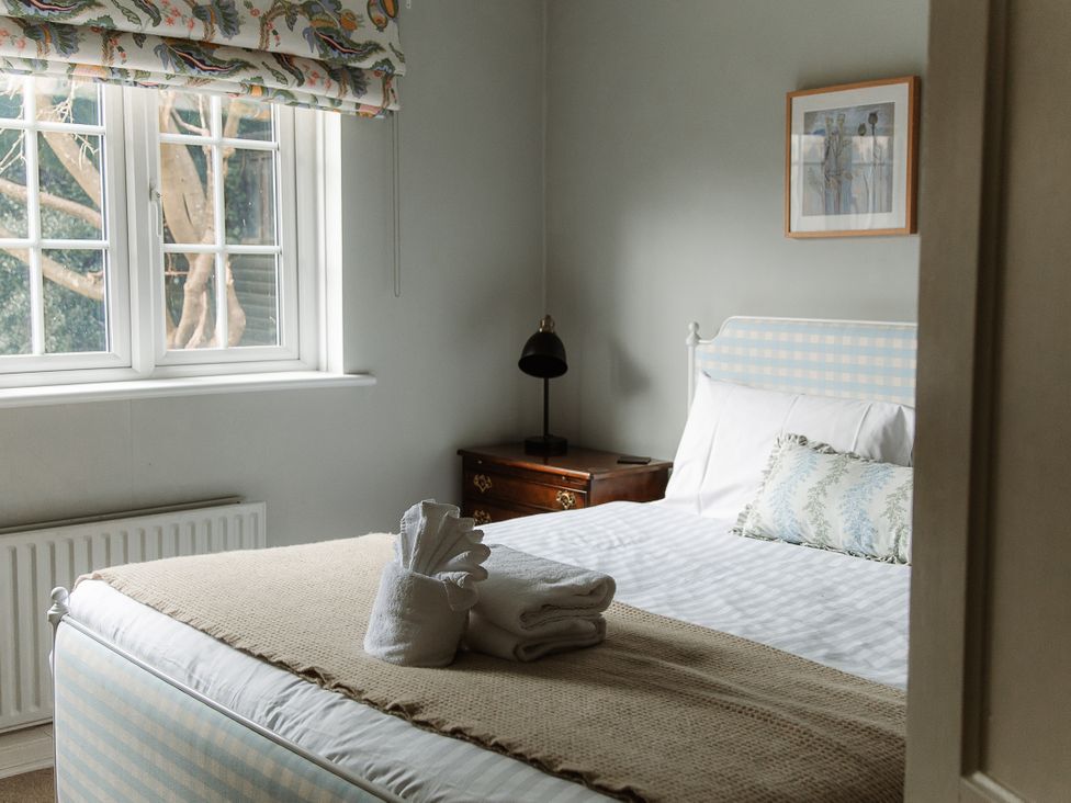 A bedroom with a bed and lamp at Grey Walls in Glenridding