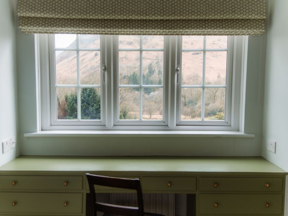 An office with a desk and a chair overlooking a mountain view at Grey Walls in Glenridding
