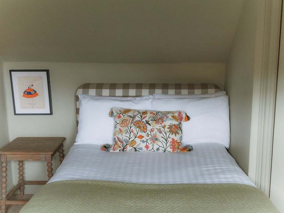 A bedroom with a bed and bedside table at Grey Walls in Glenridding