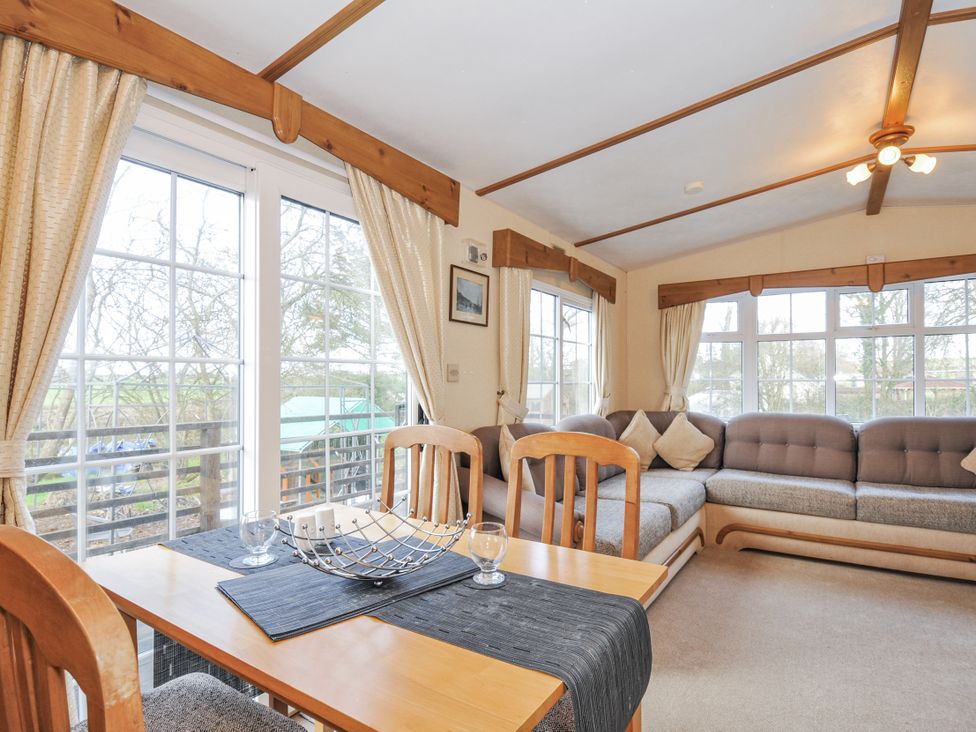 A living room with a table and sofa at Little Malory St Giles-On-The-Heath
