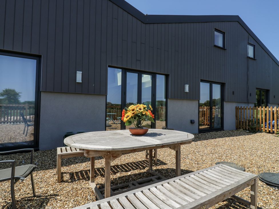 A table and chairs in an outdoor area at Little Yeat Farm (4 Bed/4 Bath) Aylesbury