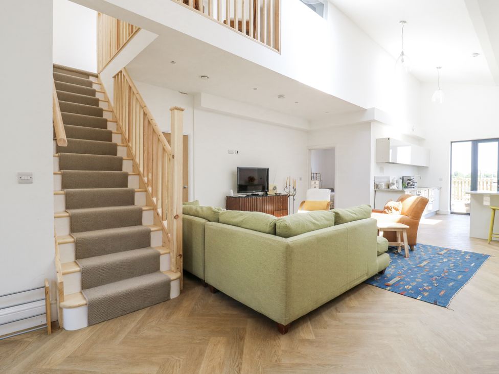 A living room with stairs and a sofa at Little Yeat Farm (4 Bed/4 Bath) Aylesbury