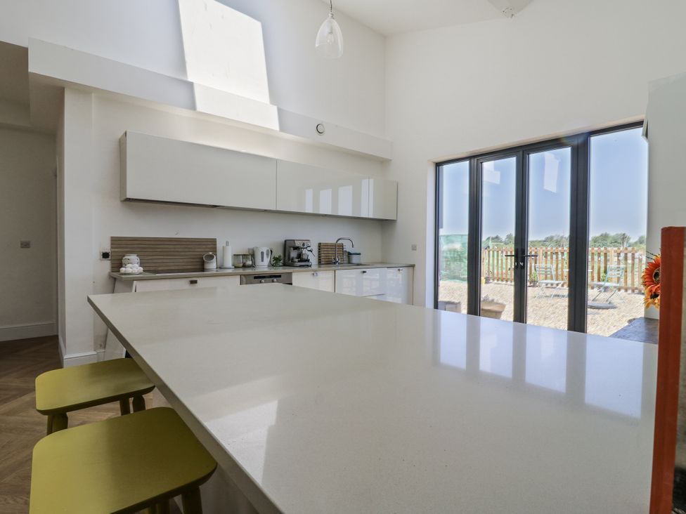 A kitchen with a large countertop and modern appliances at Little Yeat Farm in Aylesbury