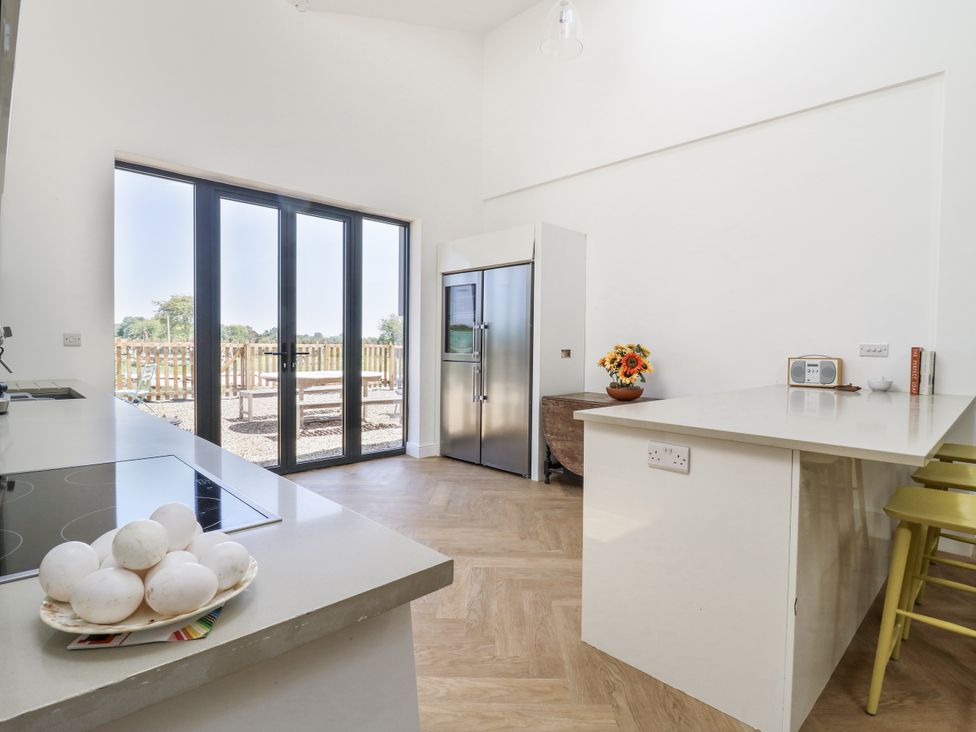 A kitchen with refrigerator and eggs on a countertop at Little Yeat Farm (4 Bed/4 Bath) Aylesbury