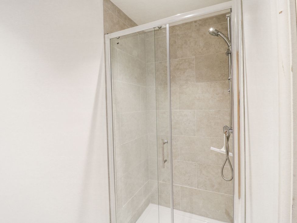 A shower with glass doors and tiled walls at Little Yeat Farm (4 Bed/4 Bath) Aylesbury