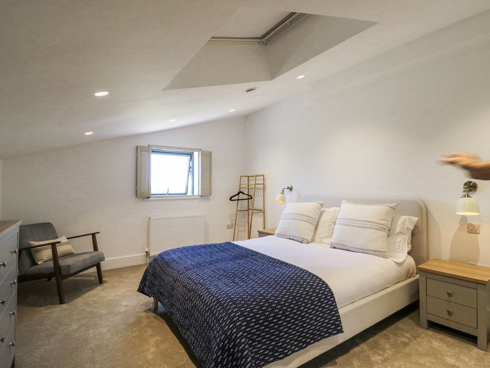 A bedroom with a bed and chair at Little Yeat Farm (4 Bed/4 Bath) in Aylesbury