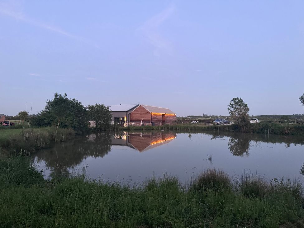 A building by a pond at Number 2 The Barn House Woodham