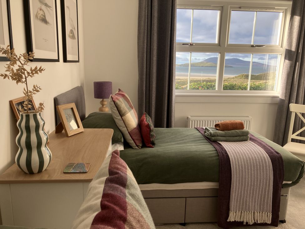 A bedroom with a bed and desk at Taigh Marsaili, Luskentyre, Isle Of Harris