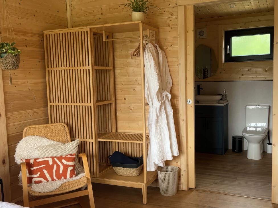 A bathroom with a toilet and wash basin at Primrose in Higher Wambrook near Chard