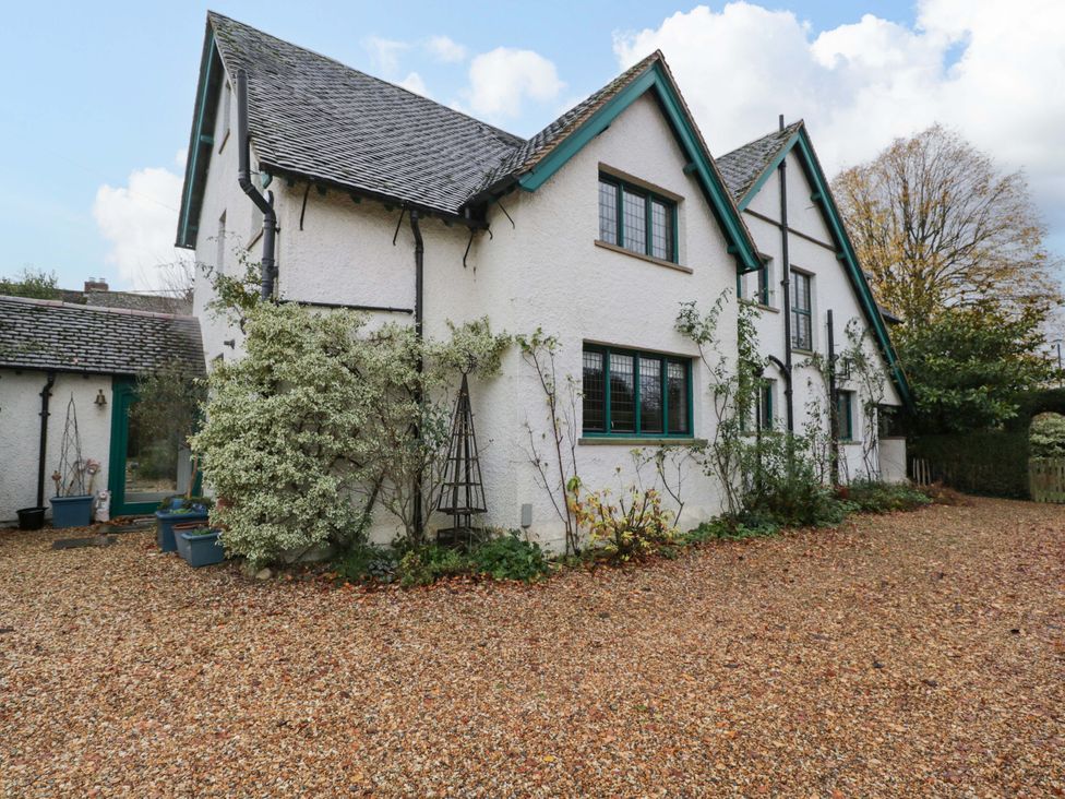 An exterior view of a house with a gravel driveway and plants at White House 