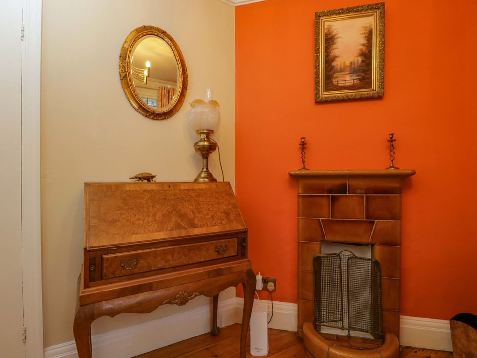 A living room with a writing desk and fireplace at White House