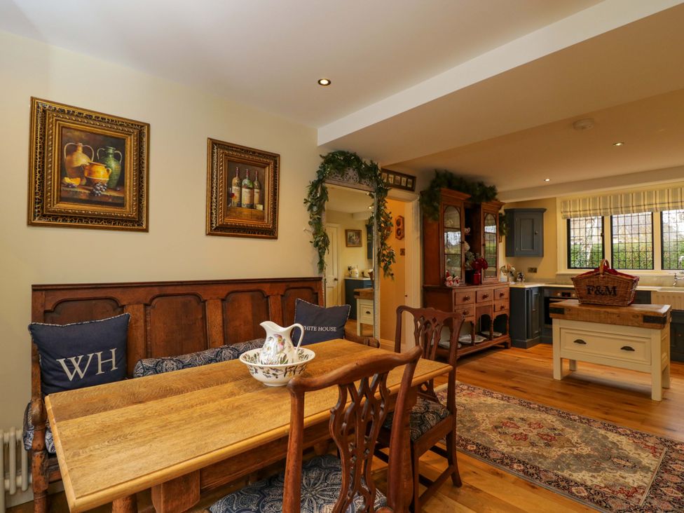 A dining room with a wooden table and chairs at White House