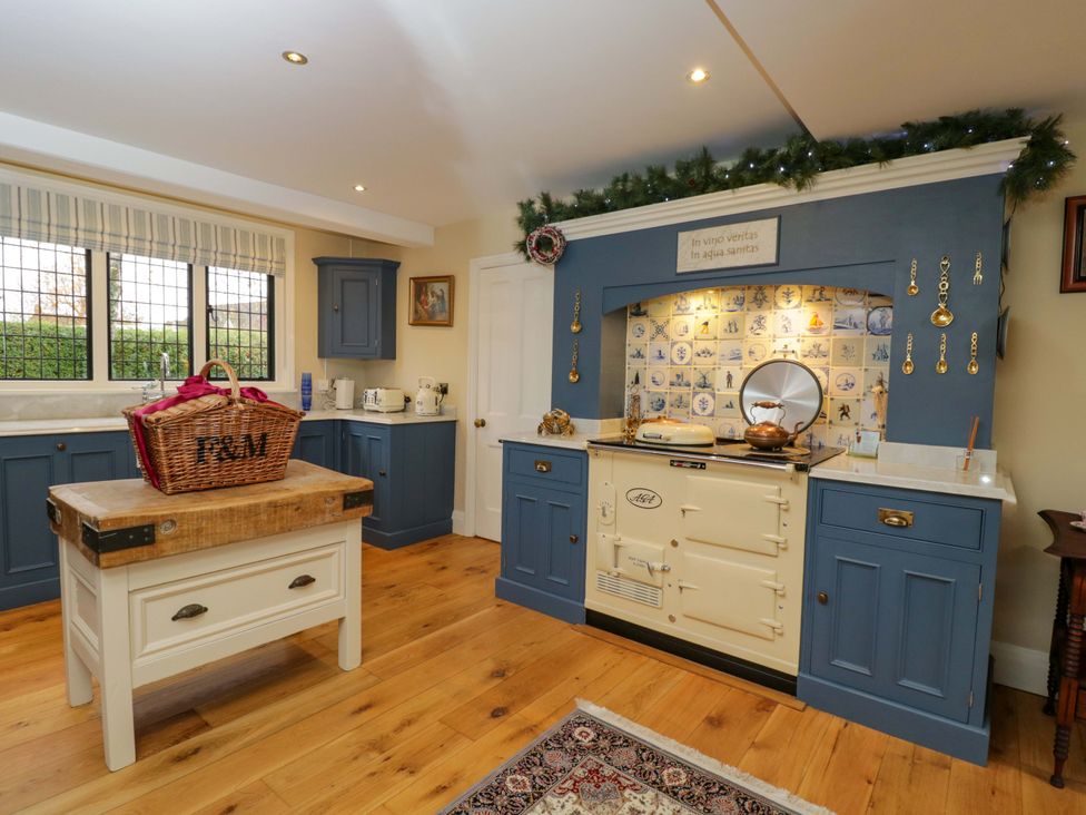 A kitchen with blue cabinetry and an oven at White House 