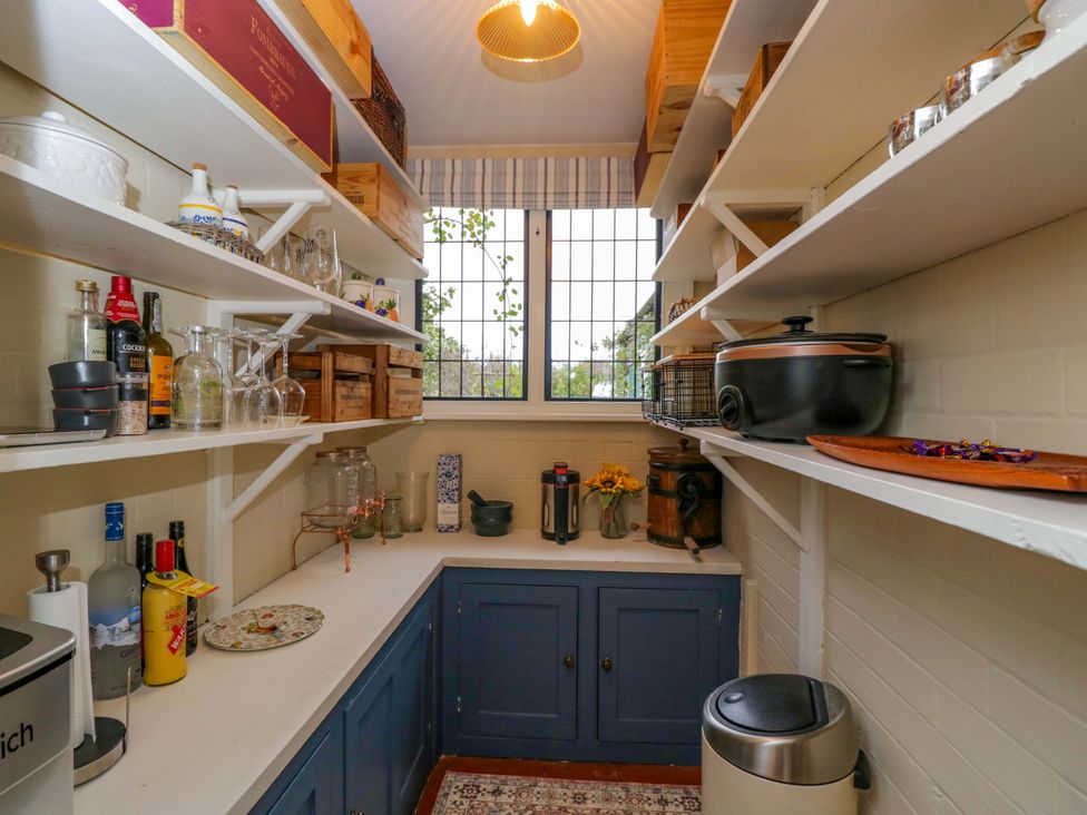 A kitchen with shelves of bottles and glasses at White House in 