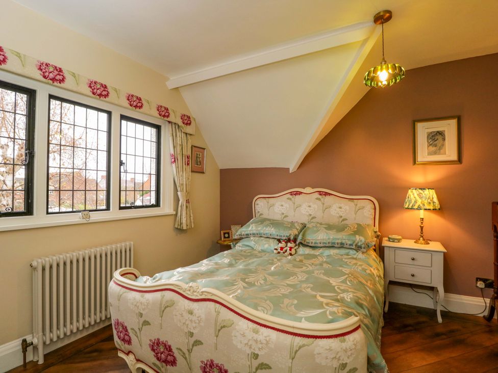 A bedroom with a bed and bedside table at White House