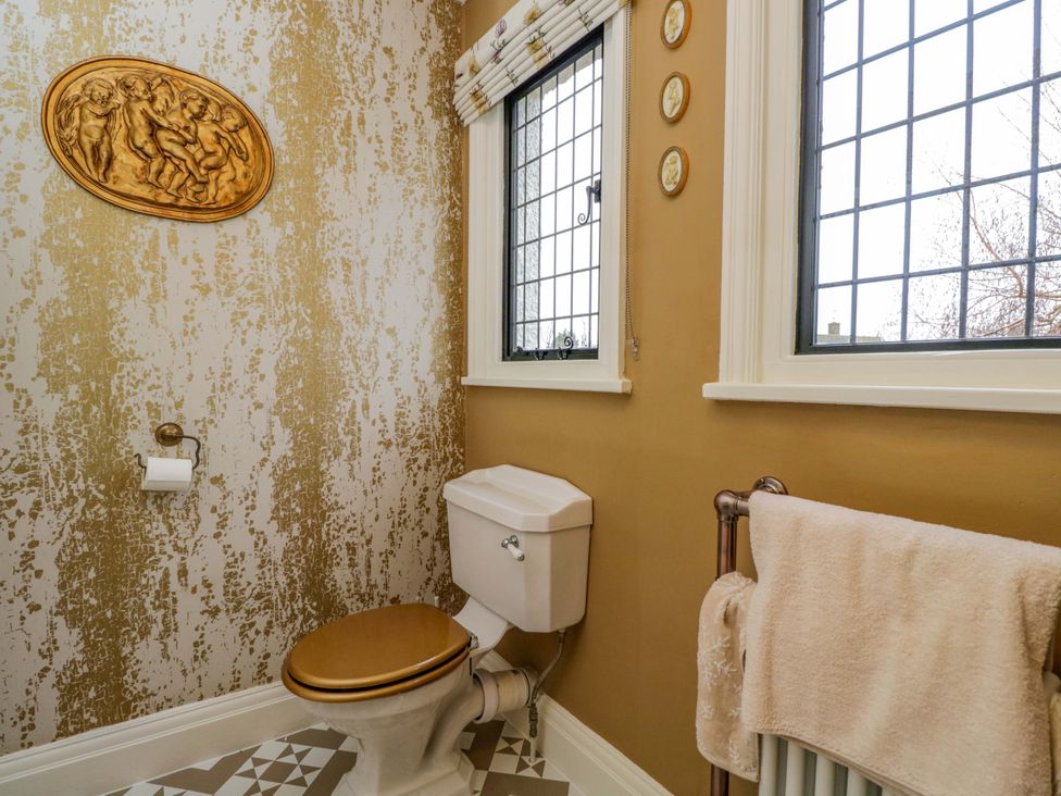 A bathroom with a toilet and windows at White House