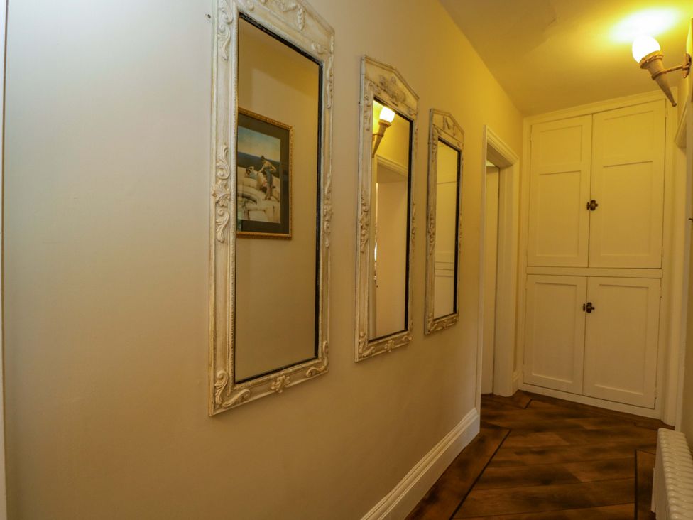 A hallway with mirrors and a cabinet at White House 