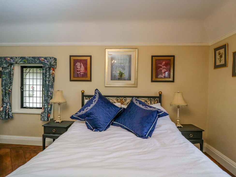 A bedroom with a bed and two framed artworks at White House