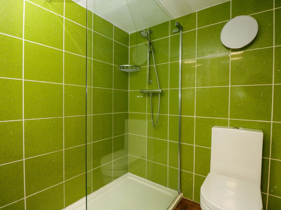 A bathroom with a shower, toilet, and sink at White House