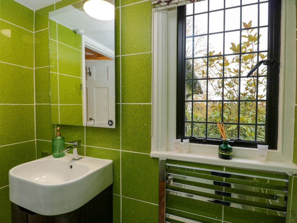 A bathroom with a sink and mirror at White House