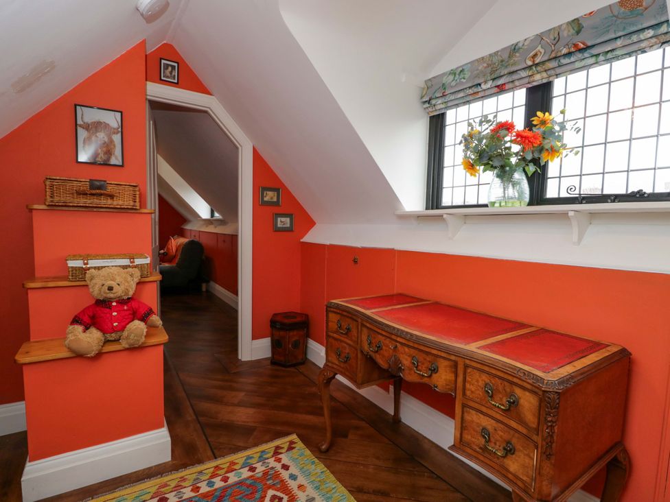 An attic with a table and teddy bear at the White House 