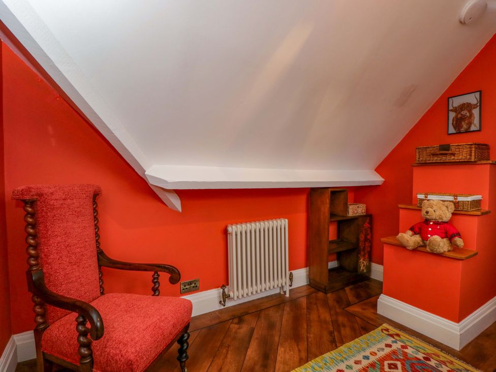 An attic with an armchair and bookshelf at White House
