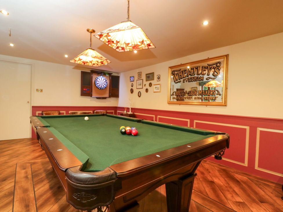 A games room with a pool table and dartboard at White House