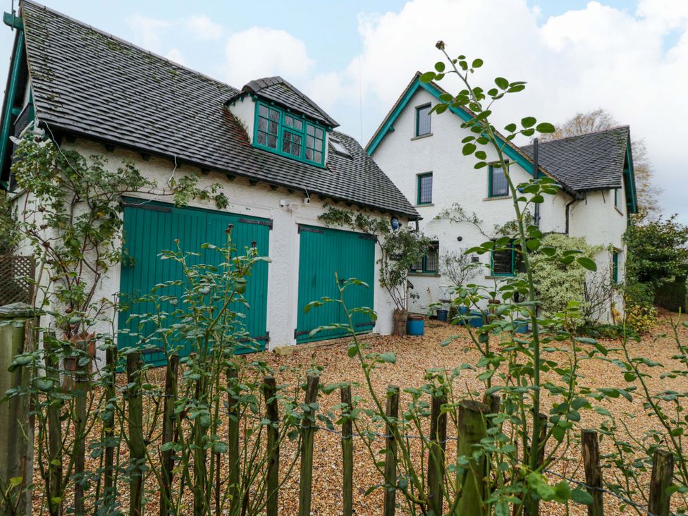 A house with turquoise garage doors and gravel driveway at White House 