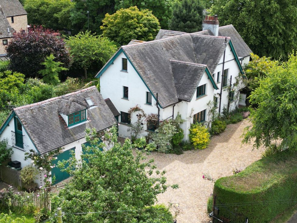 An exterior view of a house with a garage and garden at White House 