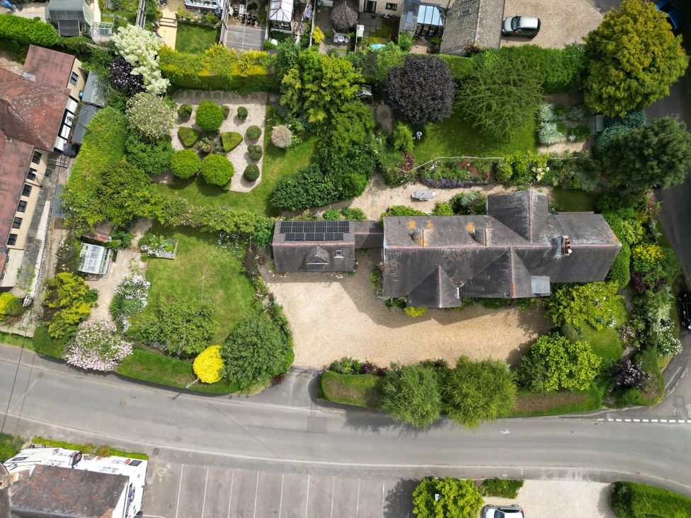 An aerial view of a house with garden and parking area at White House