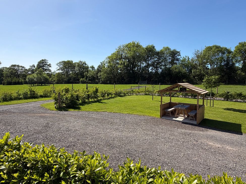A gazebo with seating area and green space at Yes Deer in Ashbourne