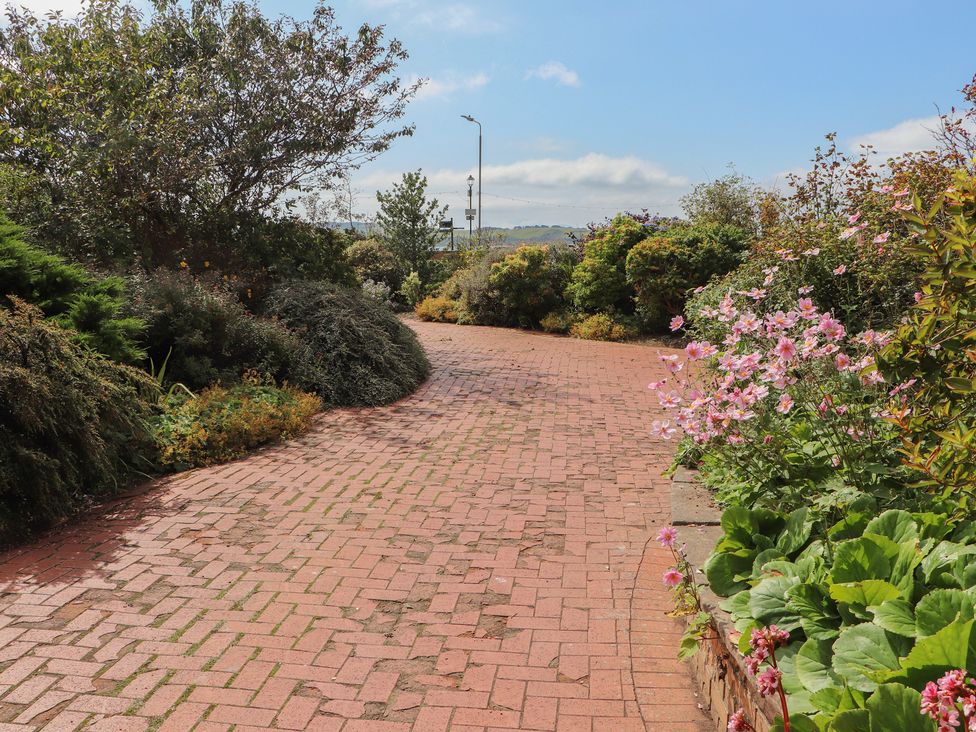 A garden pathway with flowers and bushes at The Old Rectory in Largs