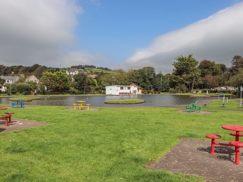 A park with a pond and benches at The Old Rectory in Largs