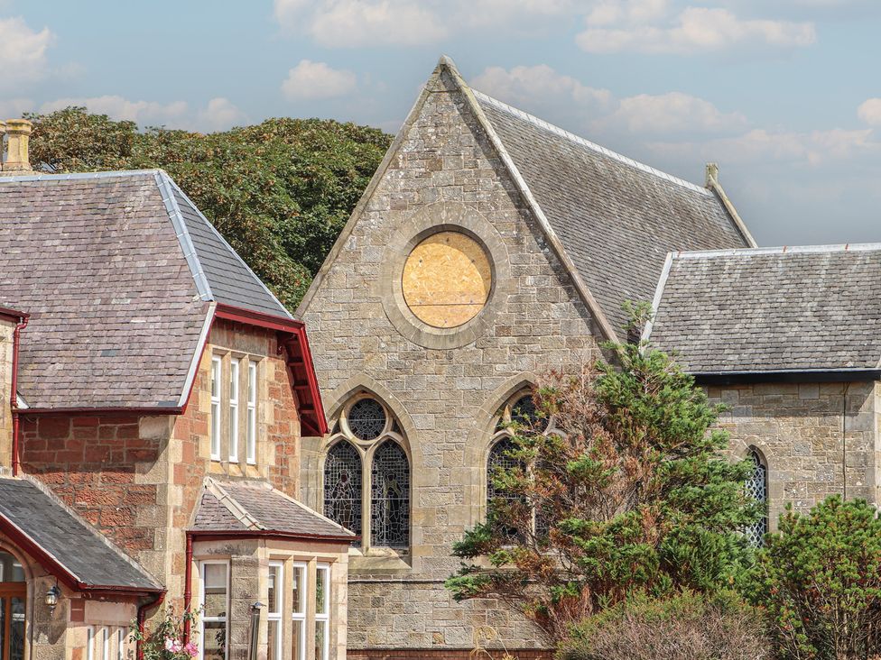 A building with a large window and roof at The Old Rectory in Largs