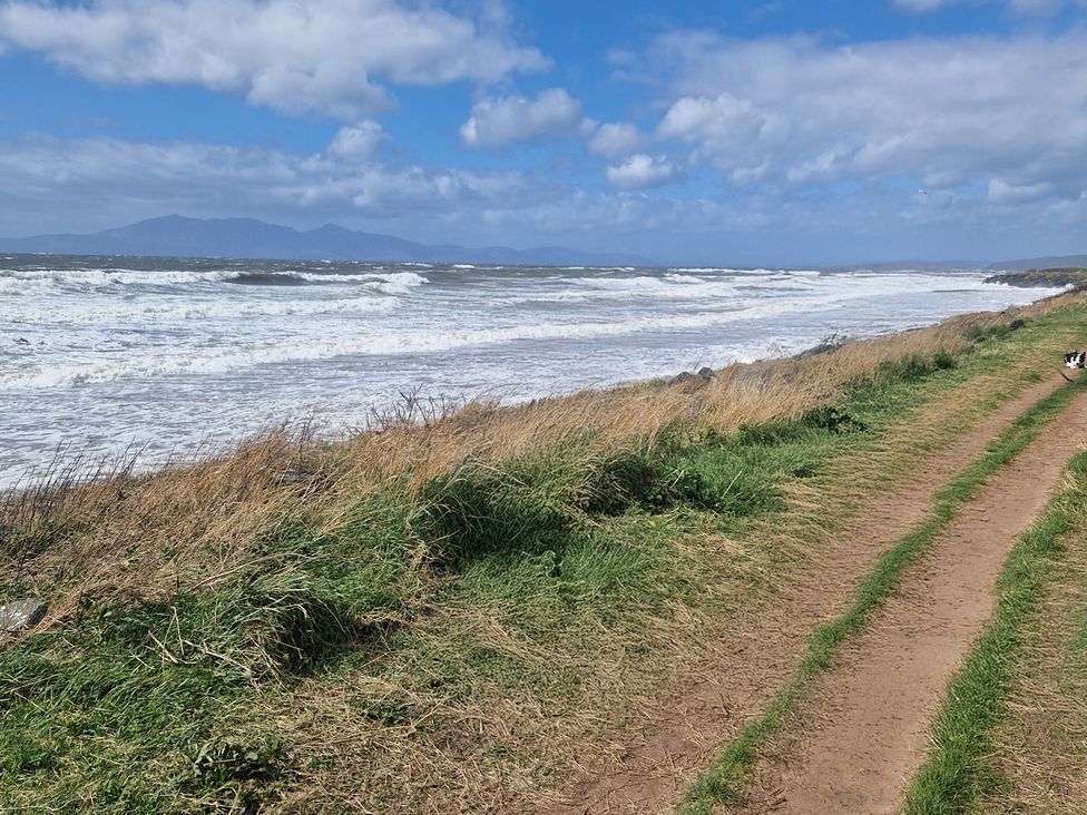 A coastal view with waves and a path at The Old Rectory in Largs