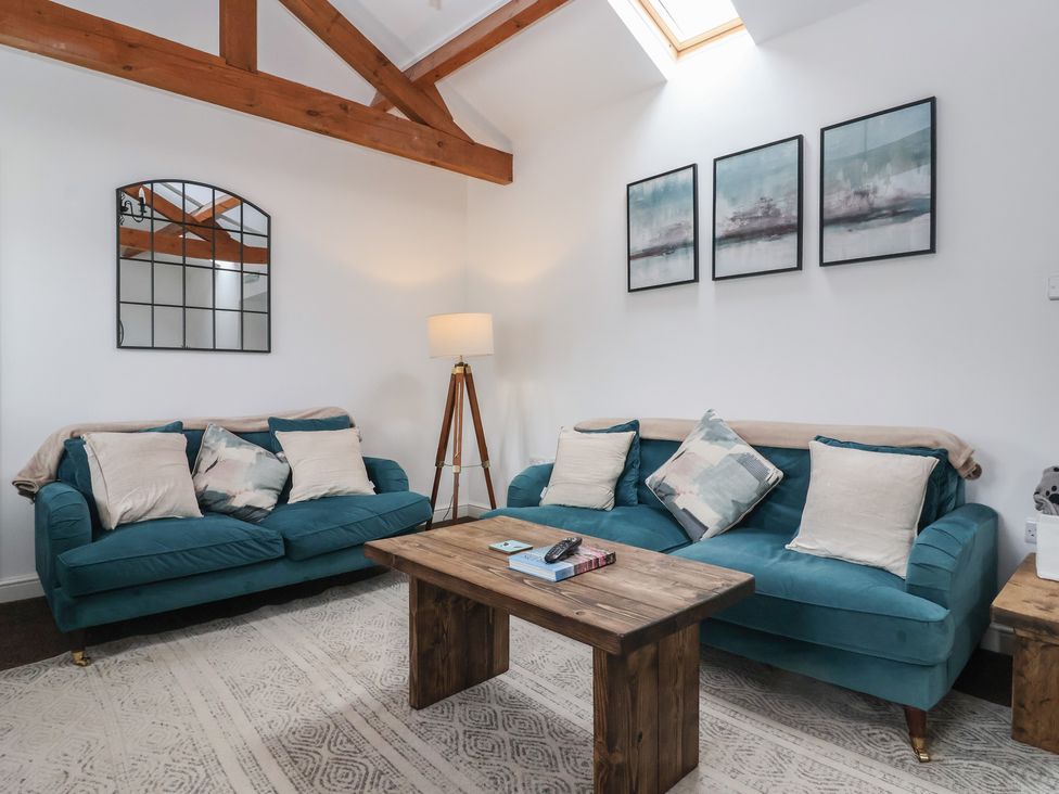 A living room with sofas and a coffee table at Gannet in Flamborough